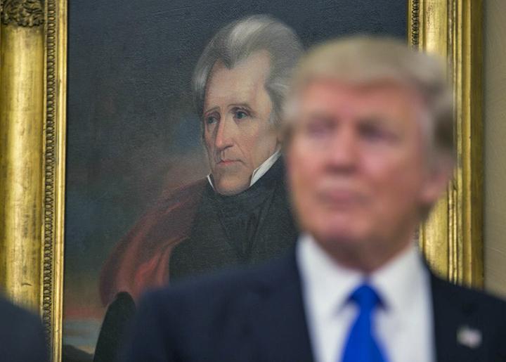 Trump speaks as Andrew Jackson looks on